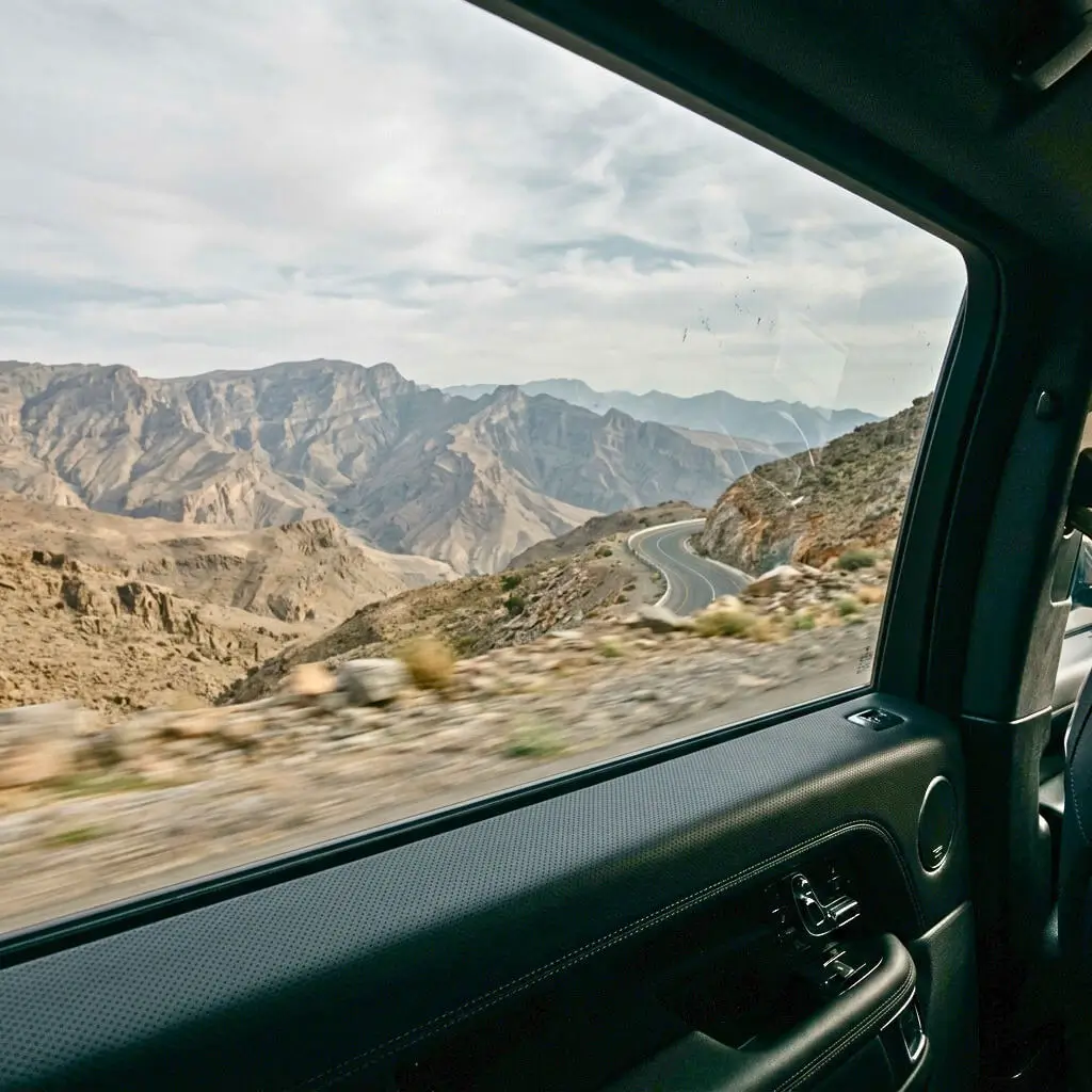 Cinematic highway entering Oman landscape